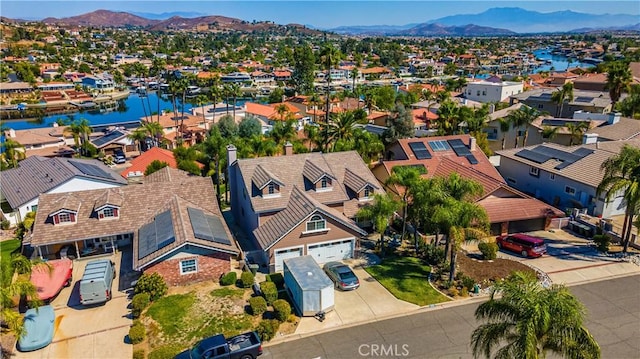 drone / aerial view with a water and mountain view