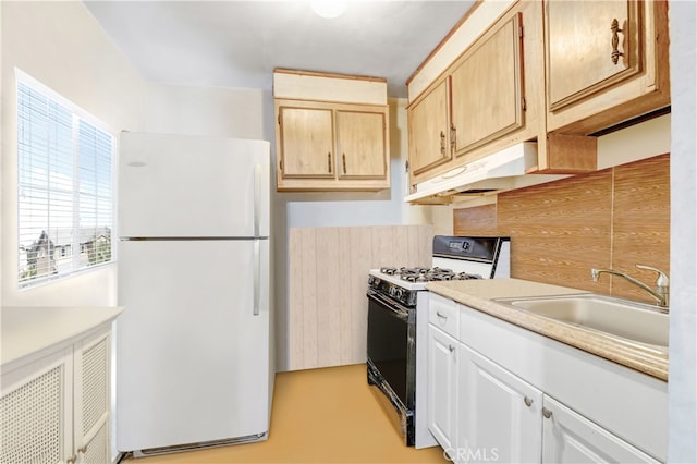 kitchen with white refrigerator, black gas stove, sink, backsplash, and light brown cabinetry