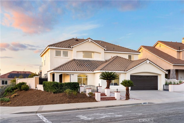 mediterranean / spanish-style house with a garage