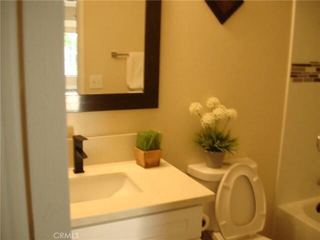 bathroom featuring vanity and toilet