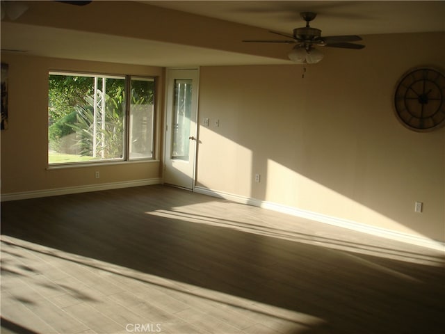 spare room featuring hardwood / wood-style floors and ceiling fan