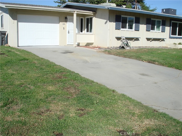 ranch-style home featuring a garage and a front yard