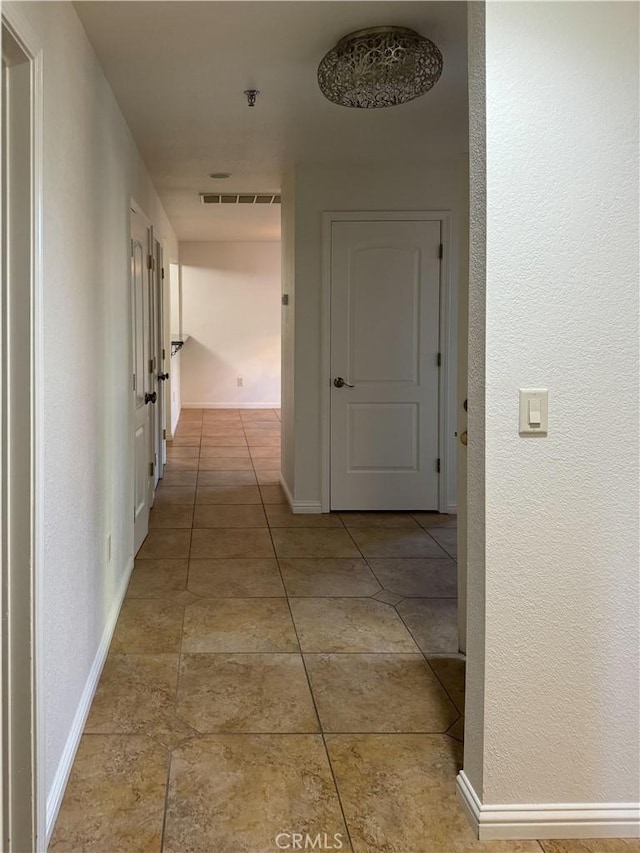 corridor with light tile patterned floors