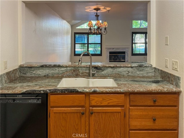 kitchen featuring a healthy amount of sunlight, dishwasher, sink, and hanging light fixtures