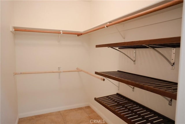 spacious closet with light tile patterned floors