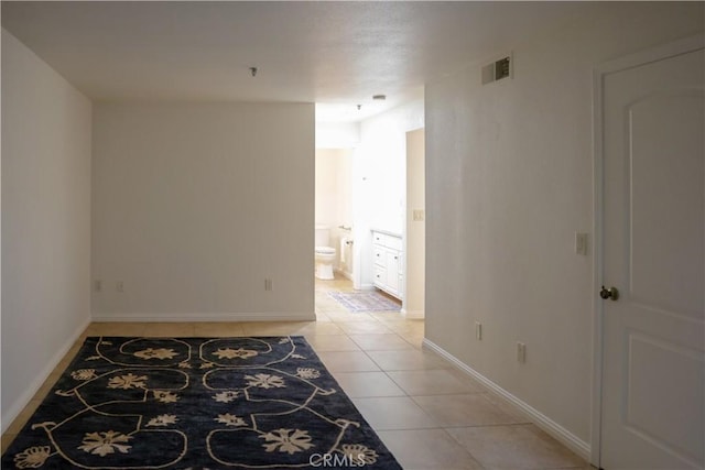 hallway featuring light tile patterned floors