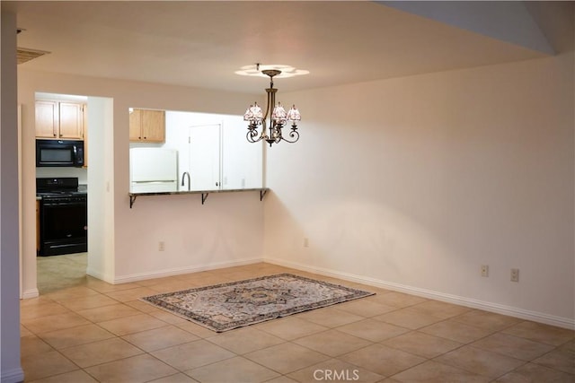 unfurnished dining area featuring a chandelier and light tile patterned floors