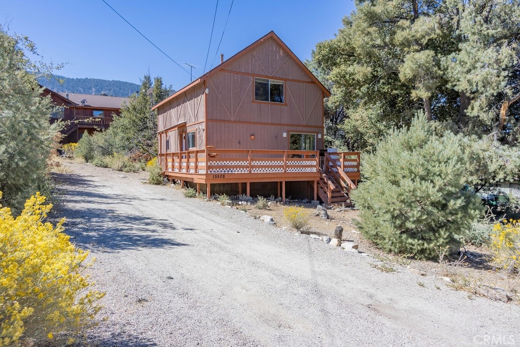 rear view of house with a deck with mountain view