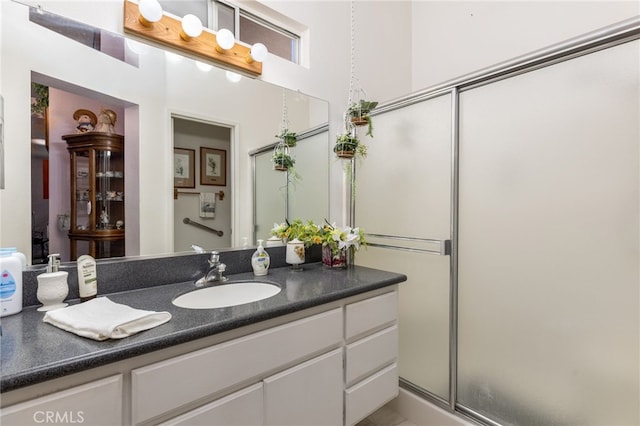 bathroom featuring an enclosed shower and vanity