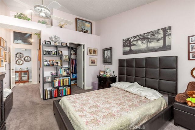 bedroom featuring carpet and a textured ceiling