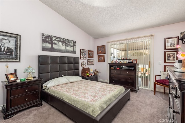 carpeted bedroom with a textured ceiling and lofted ceiling