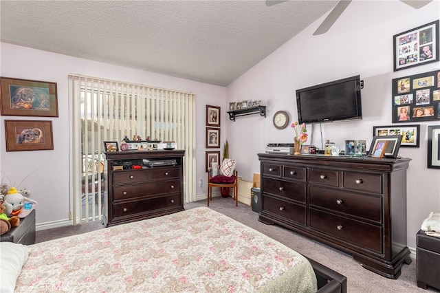 carpeted bedroom with a textured ceiling, lofted ceiling, and ceiling fan