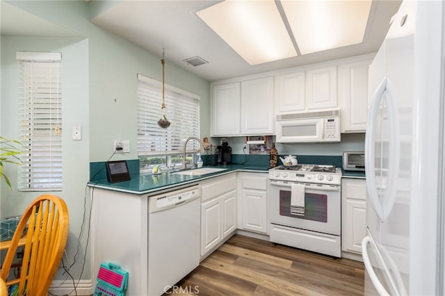 kitchen with light wood-type flooring, white appliances, sink, and white cabinets