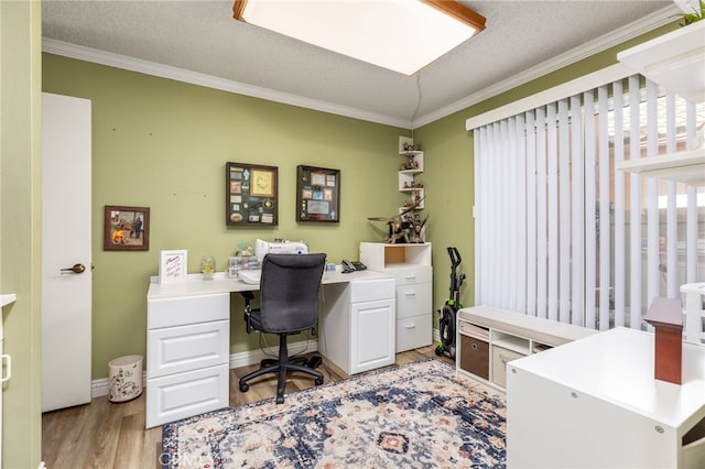 office space featuring a textured ceiling, light hardwood / wood-style floors, and crown molding