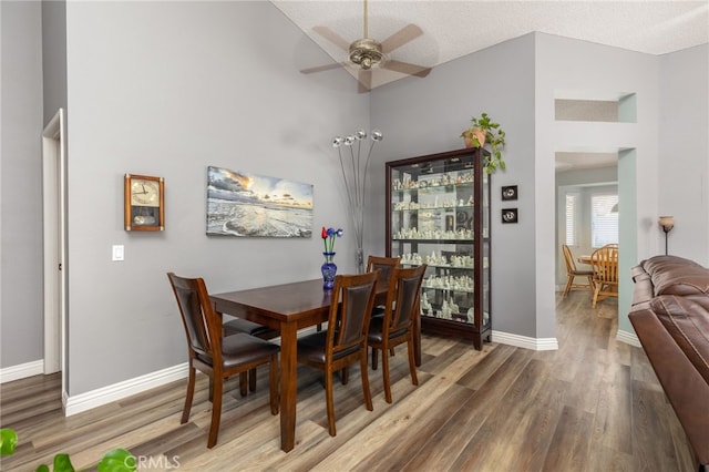 dining area featuring a textured ceiling, ceiling fan, and hardwood / wood-style flooring