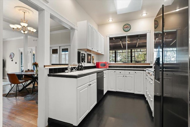 kitchen with backsplash, pendant lighting, white cabinets, dark wood-type flooring, and a notable chandelier