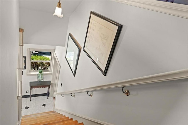 staircase with vaulted ceiling and hardwood / wood-style flooring