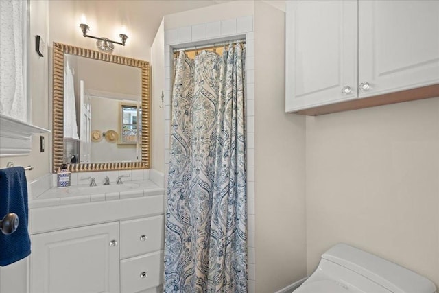 bathroom featuring toilet, vanity, and a shower with shower curtain