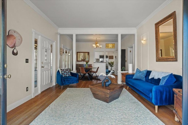 living room with ornamental molding, dark hardwood / wood-style floors, and an inviting chandelier