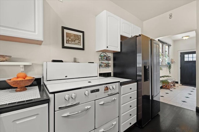 kitchen featuring dark tile patterned floors, white cabinetry, and stainless steel refrigerator with ice dispenser