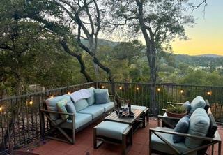 patio terrace at dusk featuring an outdoor hangout area