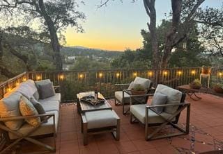 patio terrace at dusk featuring an outdoor living space