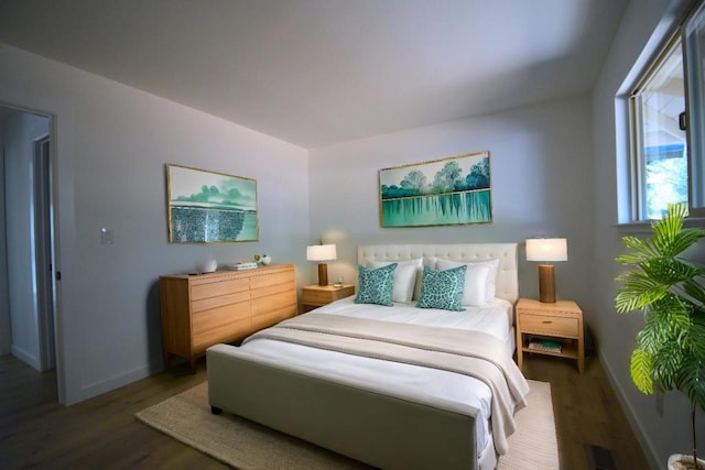 bedroom with dark wood-type flooring