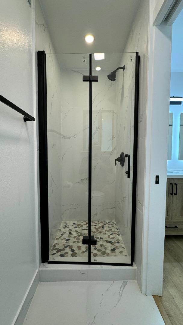 bathroom featuring a shower with door