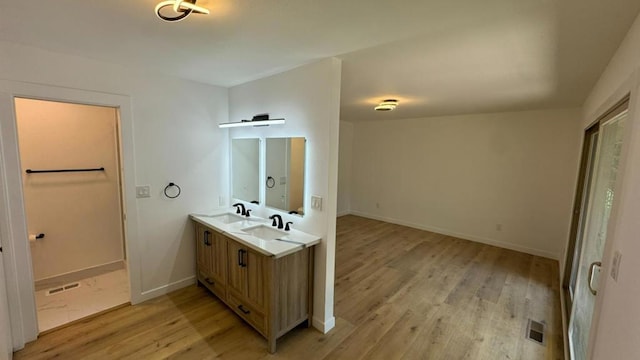 bathroom with vanity and hardwood / wood-style flooring