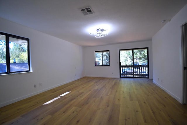 unfurnished room with wood-type flooring