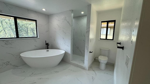 bathroom featuring toilet and separate shower and tub