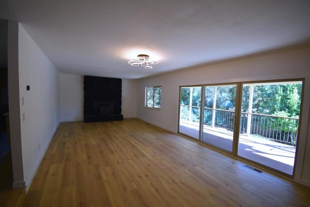 unfurnished living room with a fireplace and hardwood / wood-style flooring