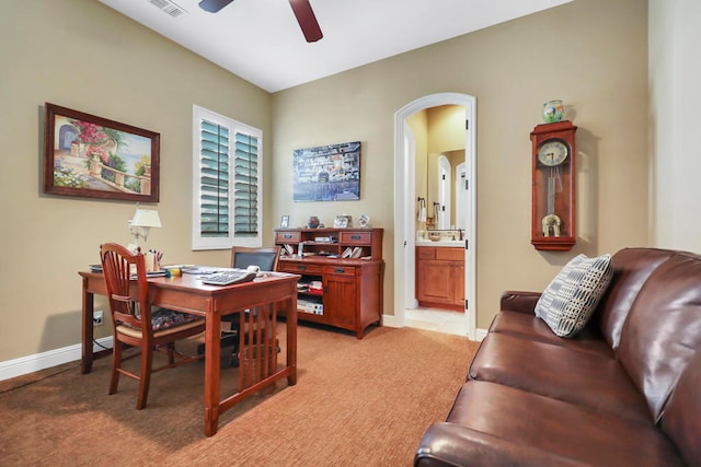 carpeted office with ceiling fan