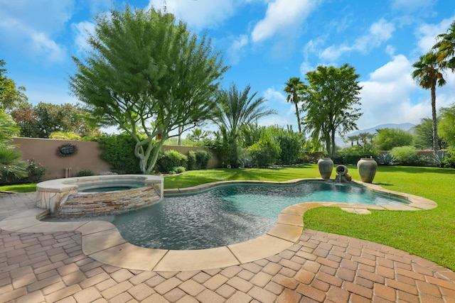 view of pool featuring a lawn, an in ground hot tub, and a patio area