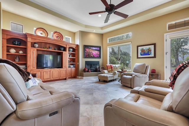 tiled living room with ceiling fan