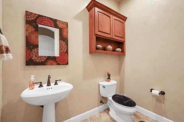 bathroom with tile patterned flooring and toilet