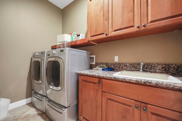 washroom with cabinets, light tile patterned floors, sink, and independent washer and dryer