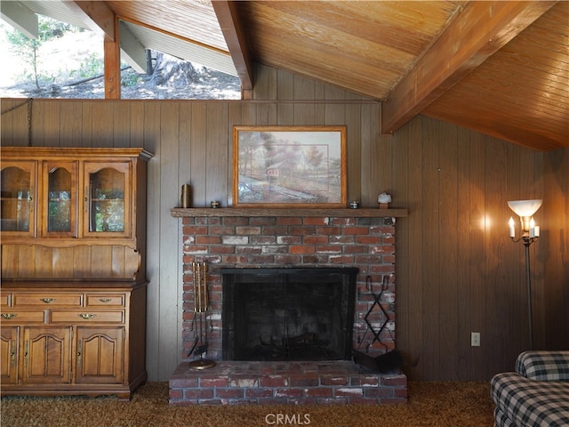 living room featuring wooden walls, lofted ceiling with beams, dark carpet, and a brick fireplace