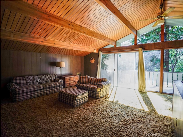 interior space featuring lofted ceiling with beams, wooden walls, ceiling fan, and wooden ceiling