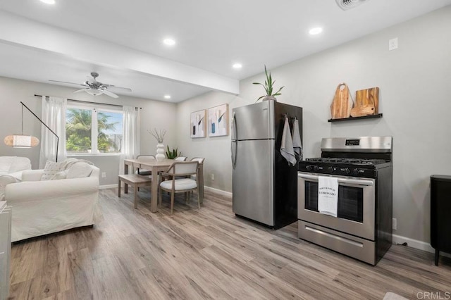 kitchen with light hardwood / wood-style floors, ceiling fan, and stainless steel appliances