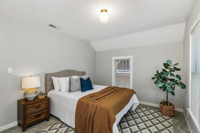 bedroom featuring carpet floors and vaulted ceiling