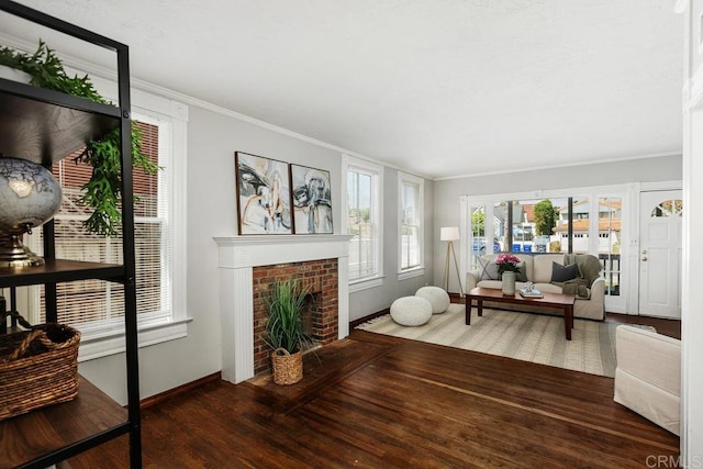 living room featuring ornamental molding, dark wood-type flooring, and a brick fireplace