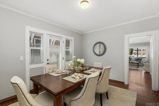 dining space featuring ornamental molding and dark wood-type flooring