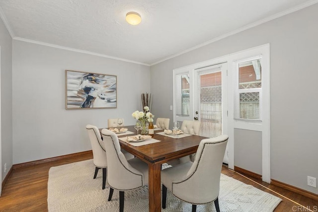 dining space featuring dark wood-type flooring and crown molding