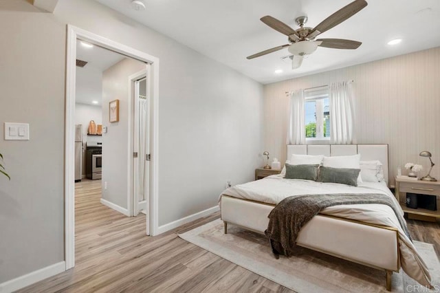 bedroom with light hardwood / wood-style floors and ceiling fan