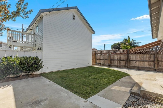 view of side of property featuring a patio and a yard