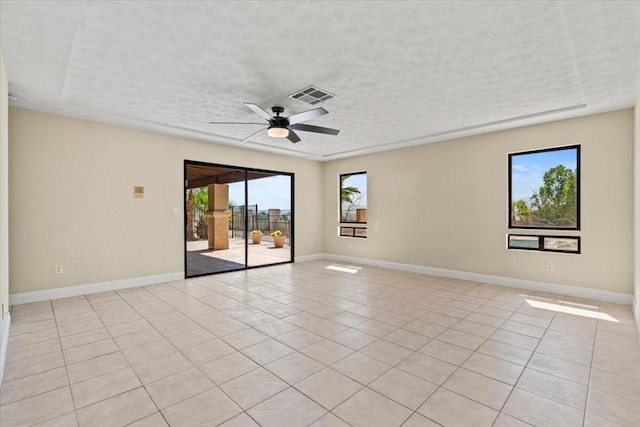 tiled spare room featuring ceiling fan and a textured ceiling