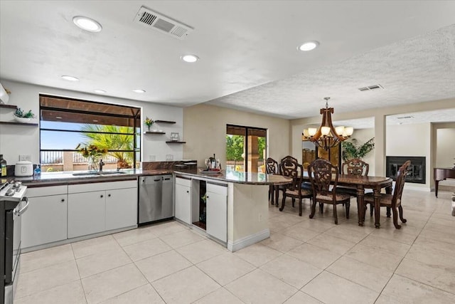 kitchen with stove, white cabinets, sink, stainless steel dishwasher, and kitchen peninsula