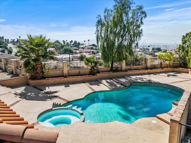 view of swimming pool featuring an in ground hot tub and a patio