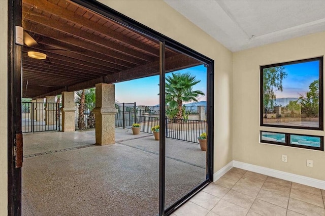 doorway featuring light tile patterned floors and a healthy amount of sunlight